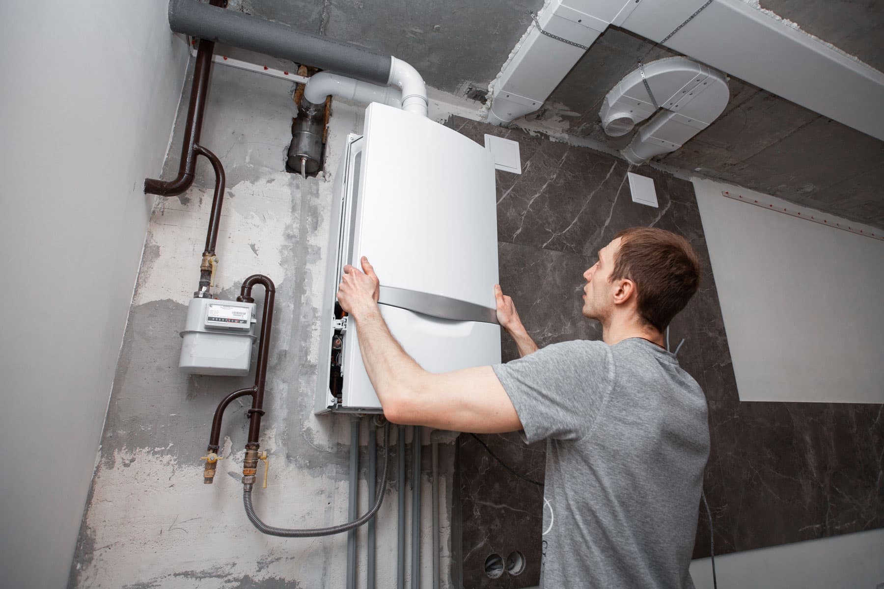 Surrey boiler technician mounting a new boiler